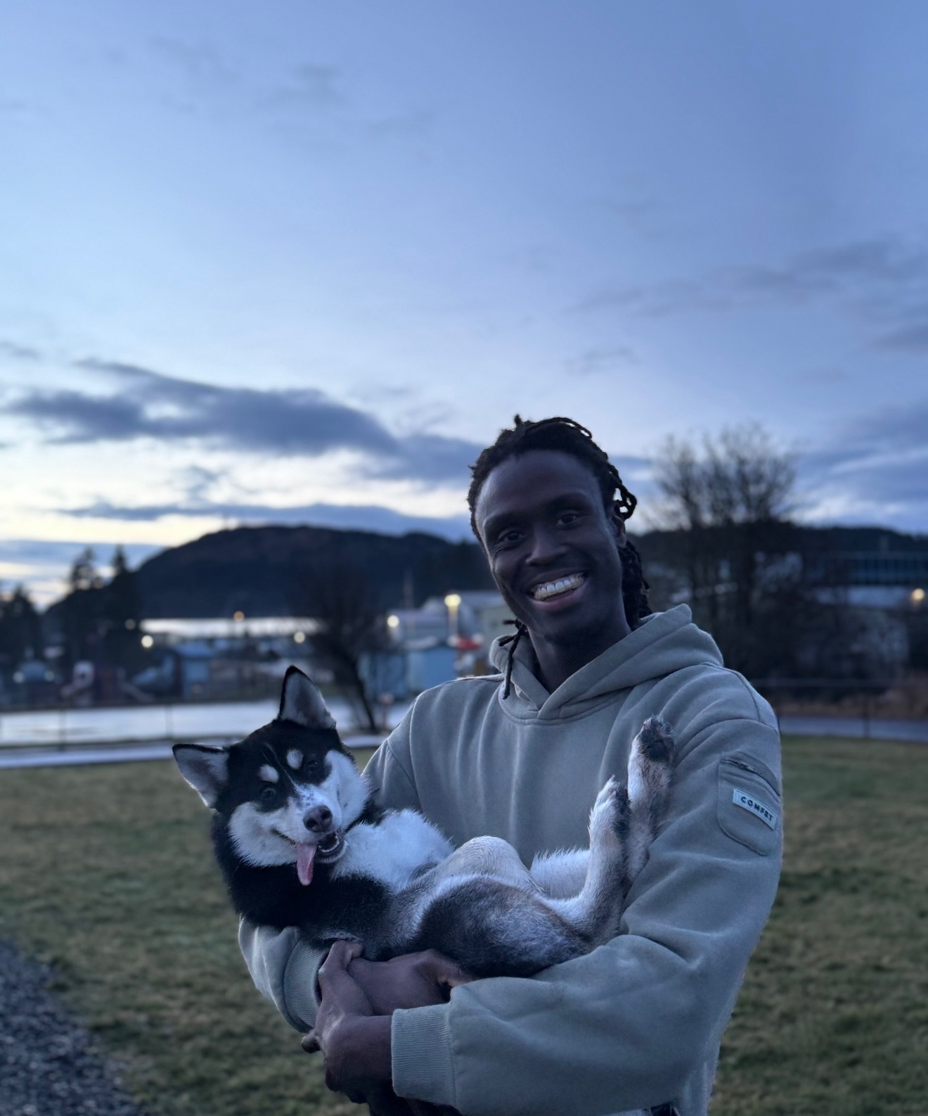Me and my dog at a Kodiak park at dusk